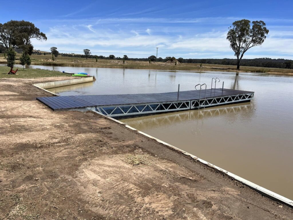 Metal pontoon on lake; side view.