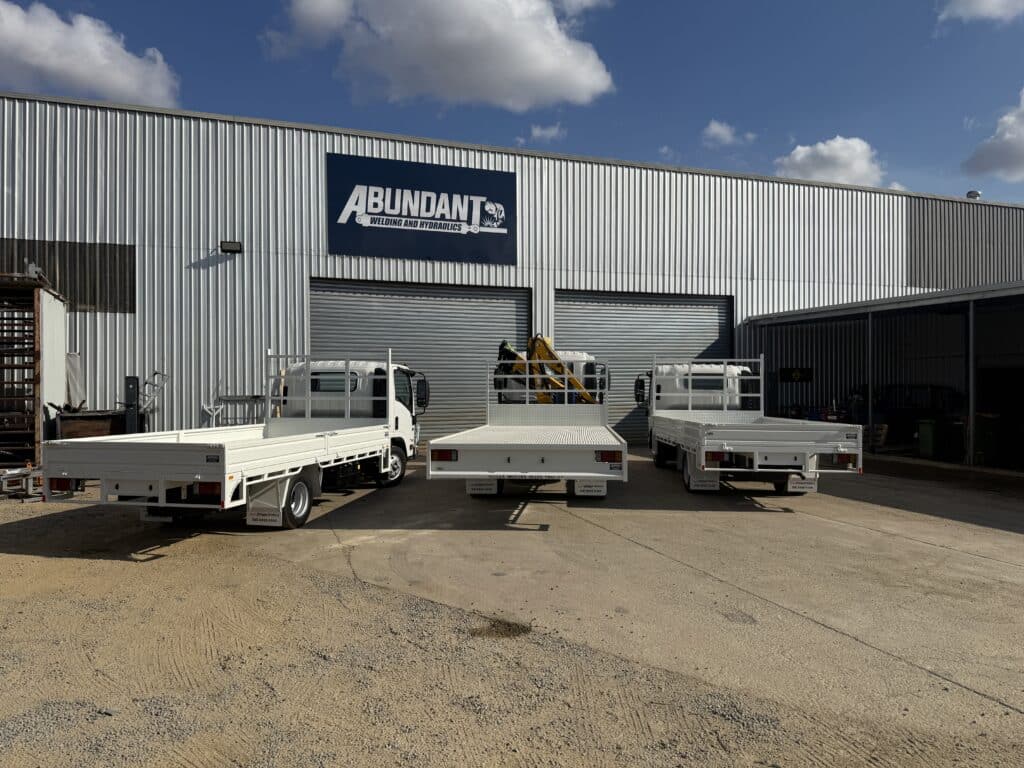 Three trucks out the front of the Abundant Welding shed.