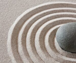 A round stone in the center of concentric circles showing our connectedness.