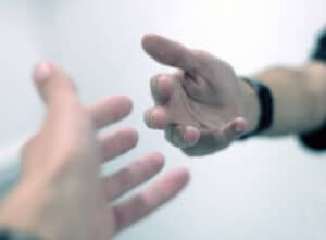 Two people reaching out to one another
