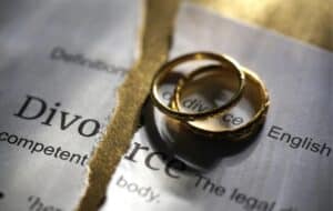 Two wedding rings sitting on top of Divorce papers.