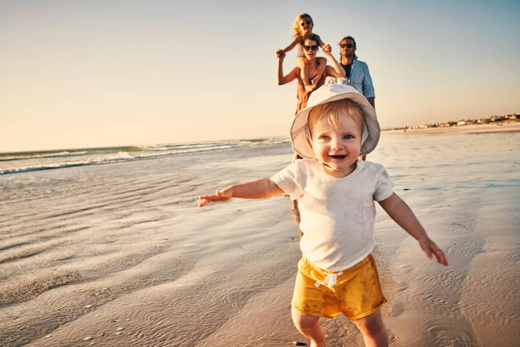 Shot of a happy young family enjoying a day at the beach