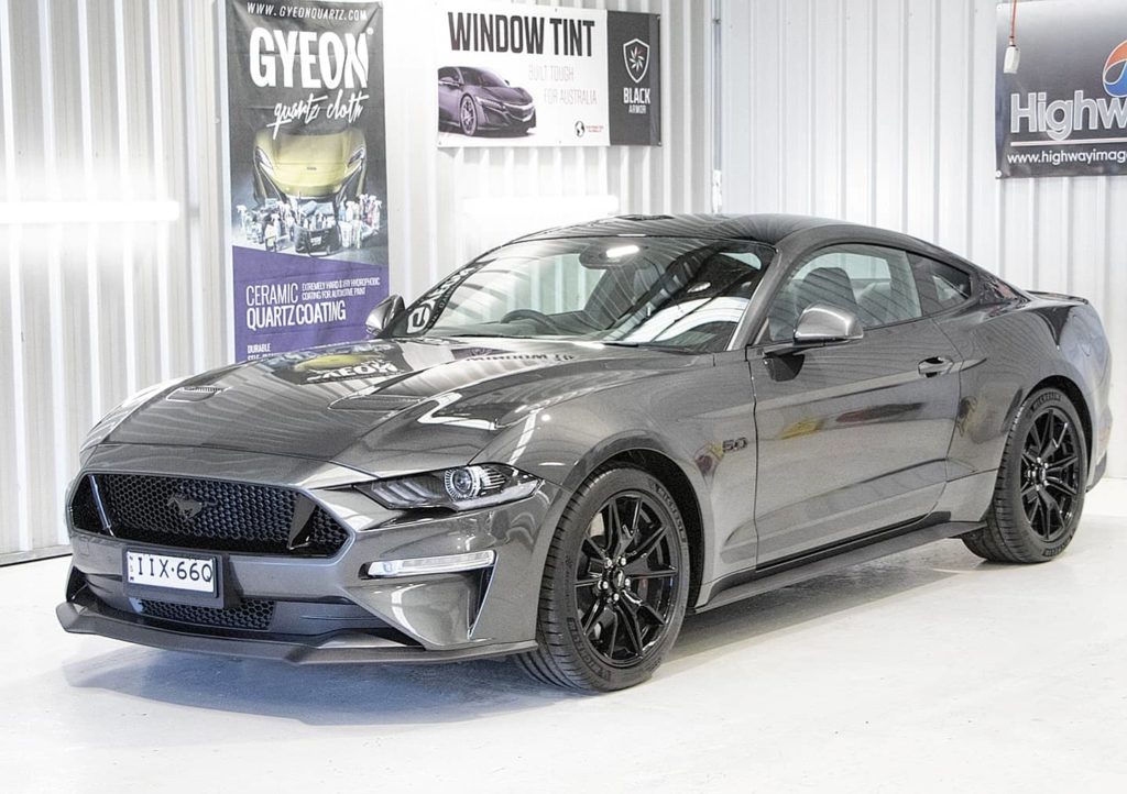 Grey Ford Mustang; side view.
