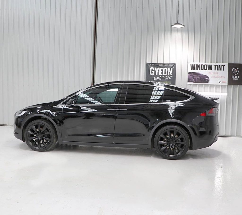 Black Tesla, side view.