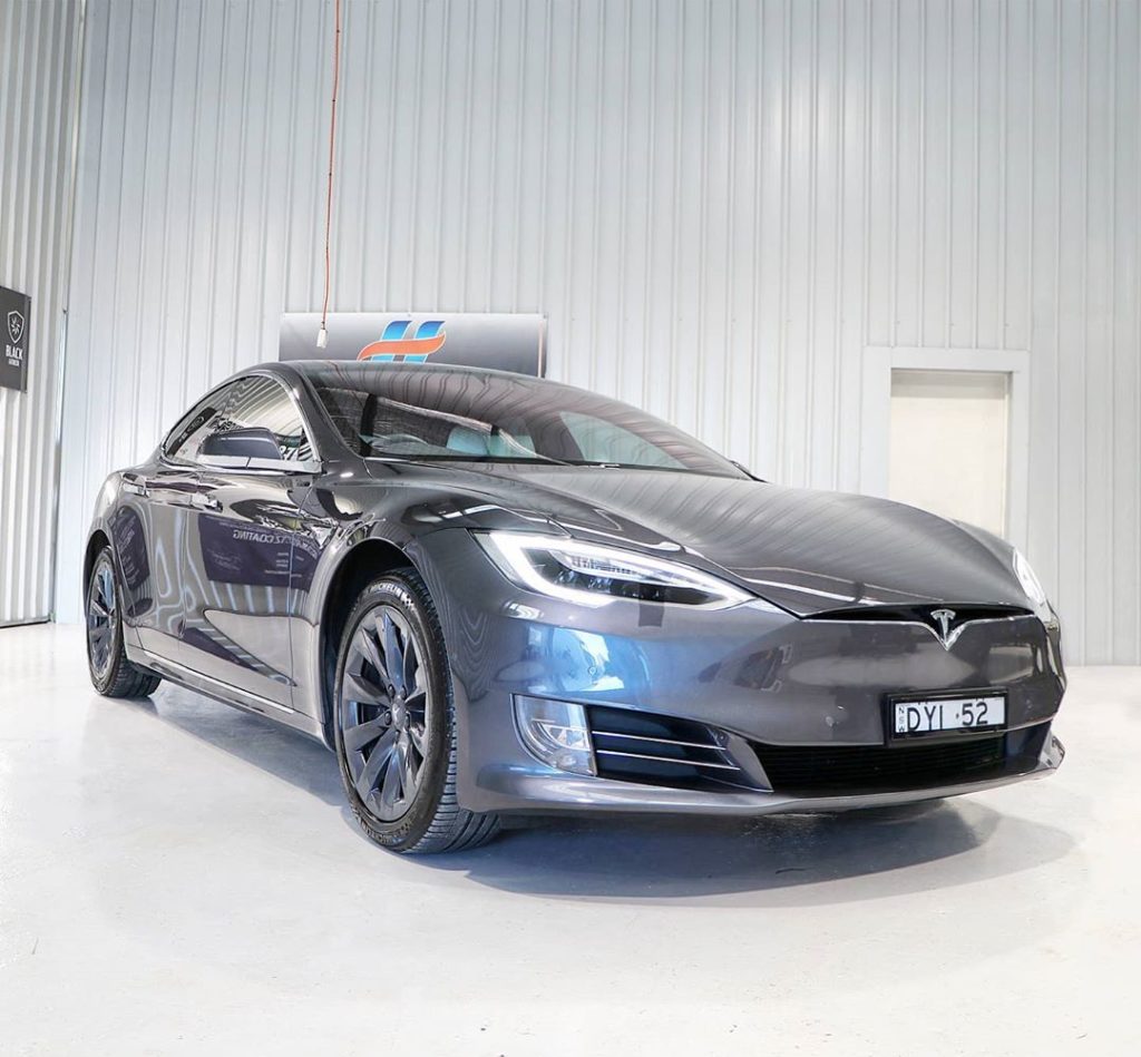 Grey Tesla, side view.