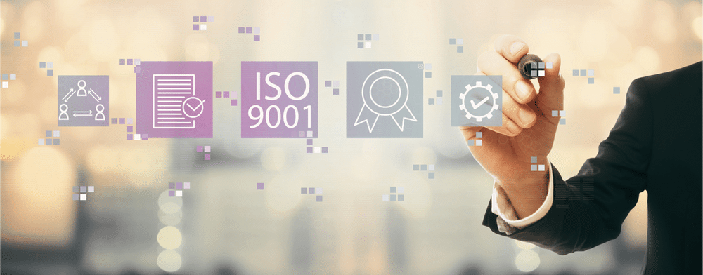 Digital image of ISO 9001 with man writing on glass whiteboard