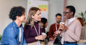 Three professionals discussing business matters