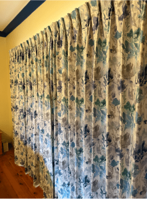 a custom made pleated curtain in a vibrant floral print.