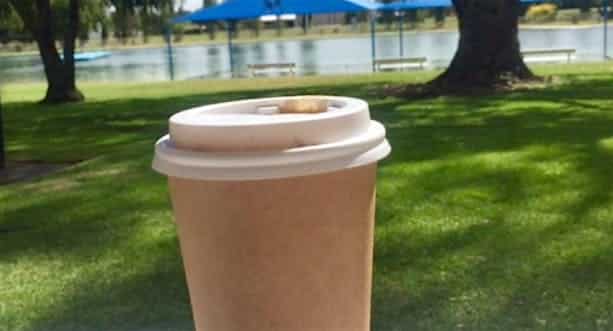 Coffee cup in front of local lake